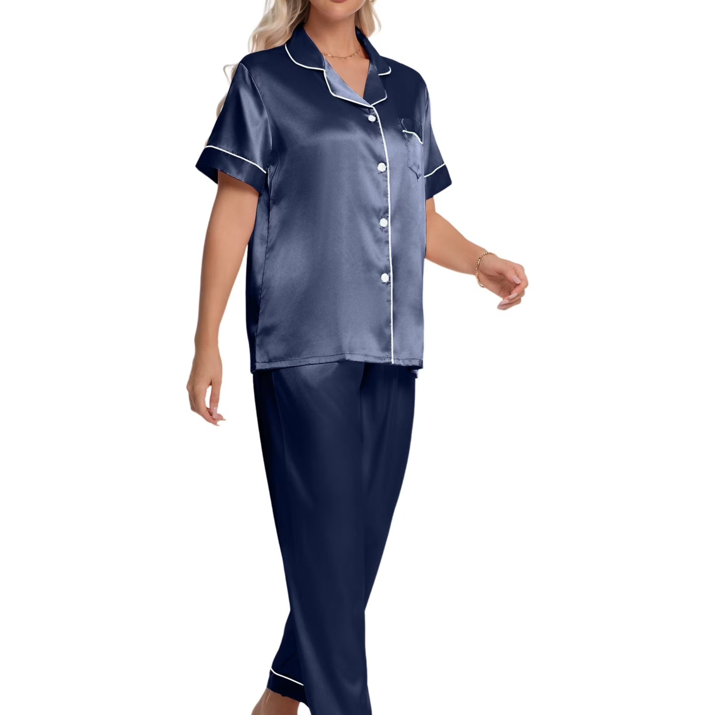 Woman wearing navy satin pajamas with white piping on a white background