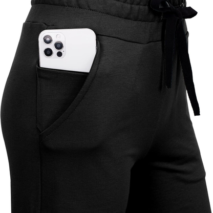 Black pants with a white phone in the pocket on a white background