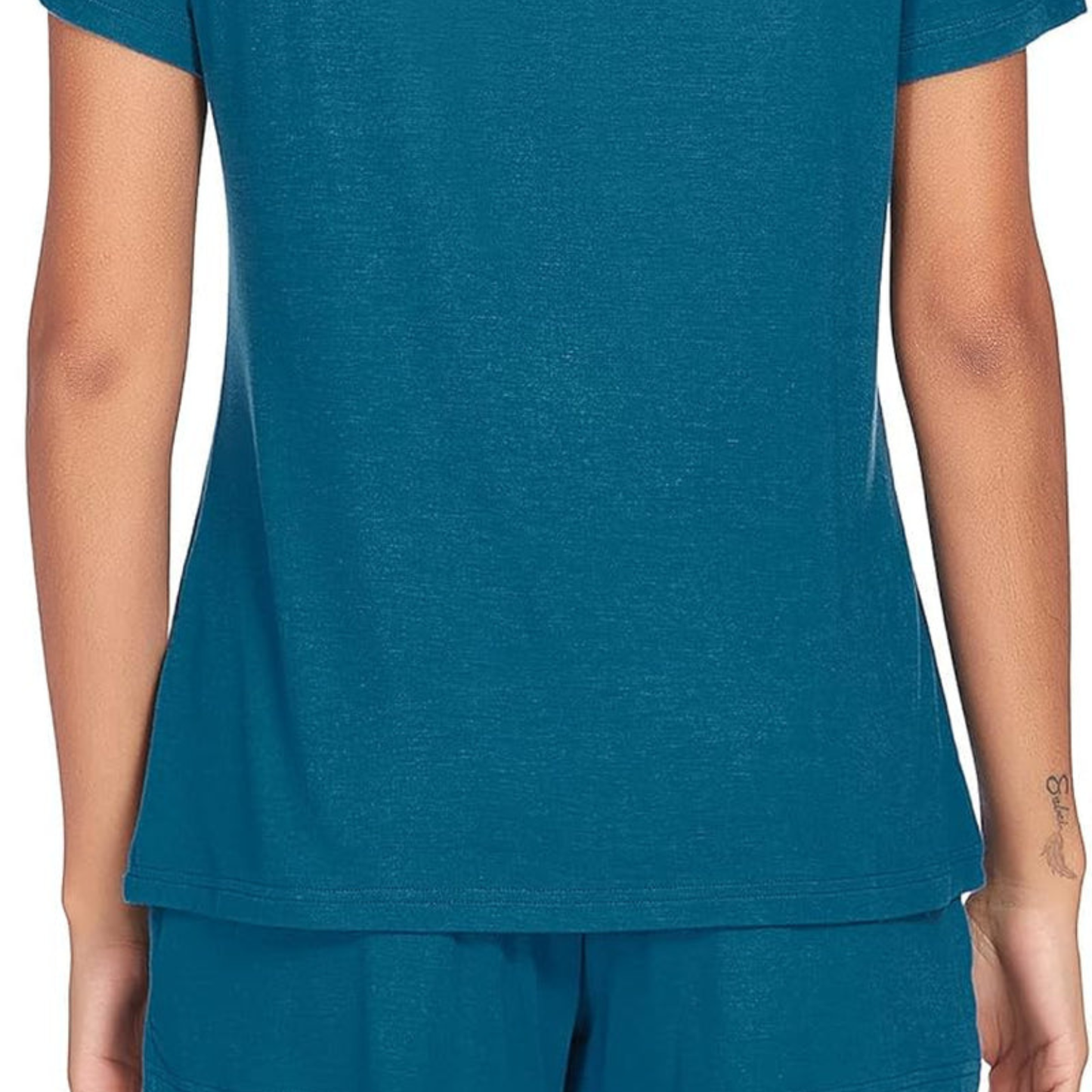 Person wearing a teal t-shirt and pants on a white background