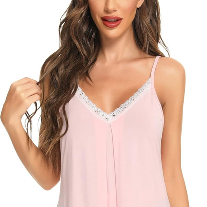 Woman wearing a pink lace-trimmed camisole against a white background