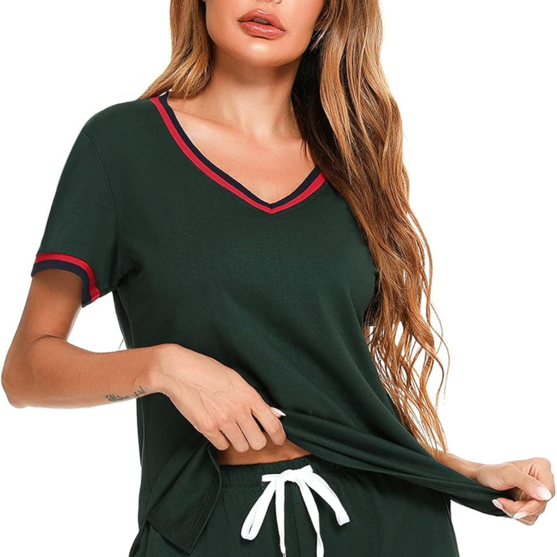 Woman wearing a green outfit with red trim on a white background