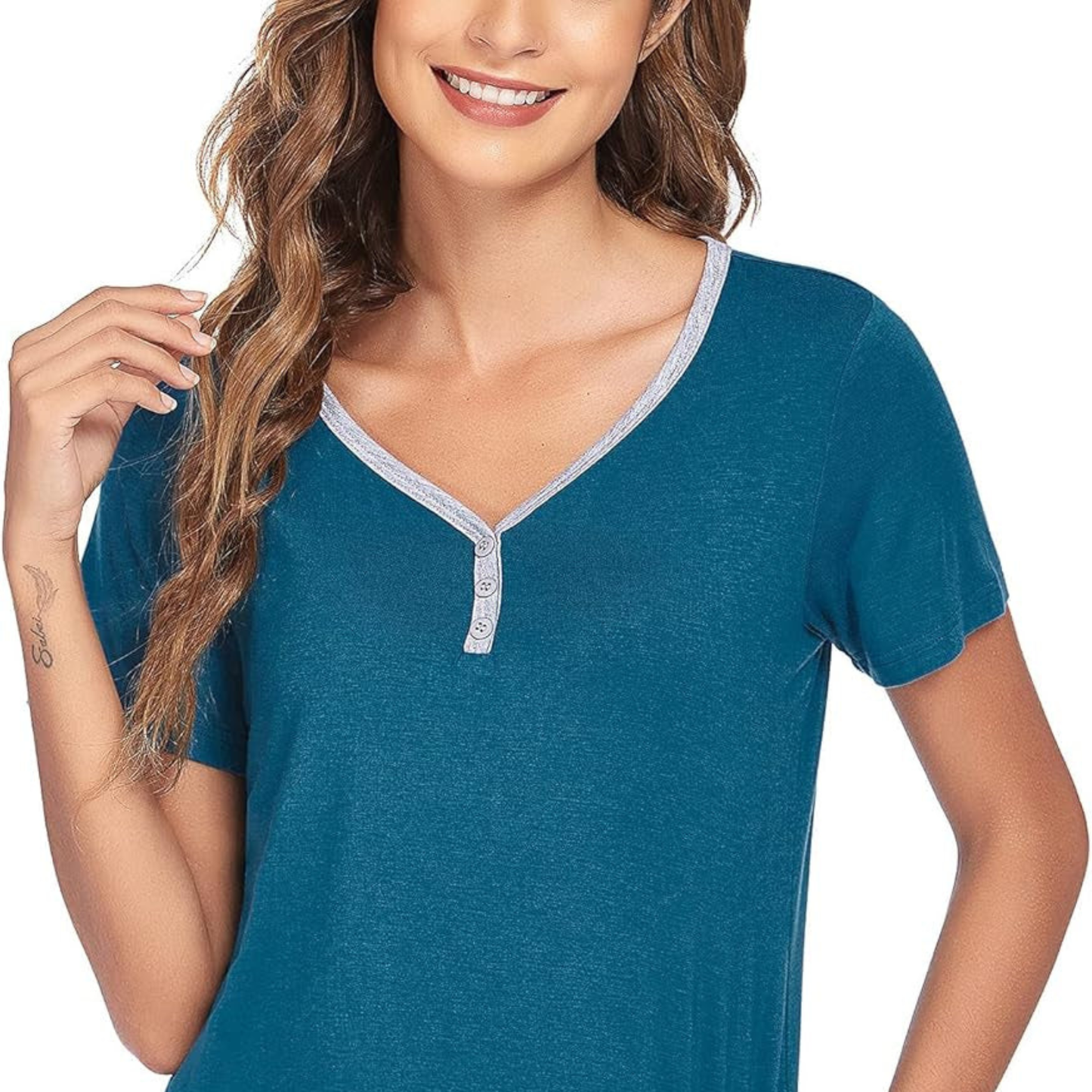 Woman wearing a teal short-sleeve shirt with a white background