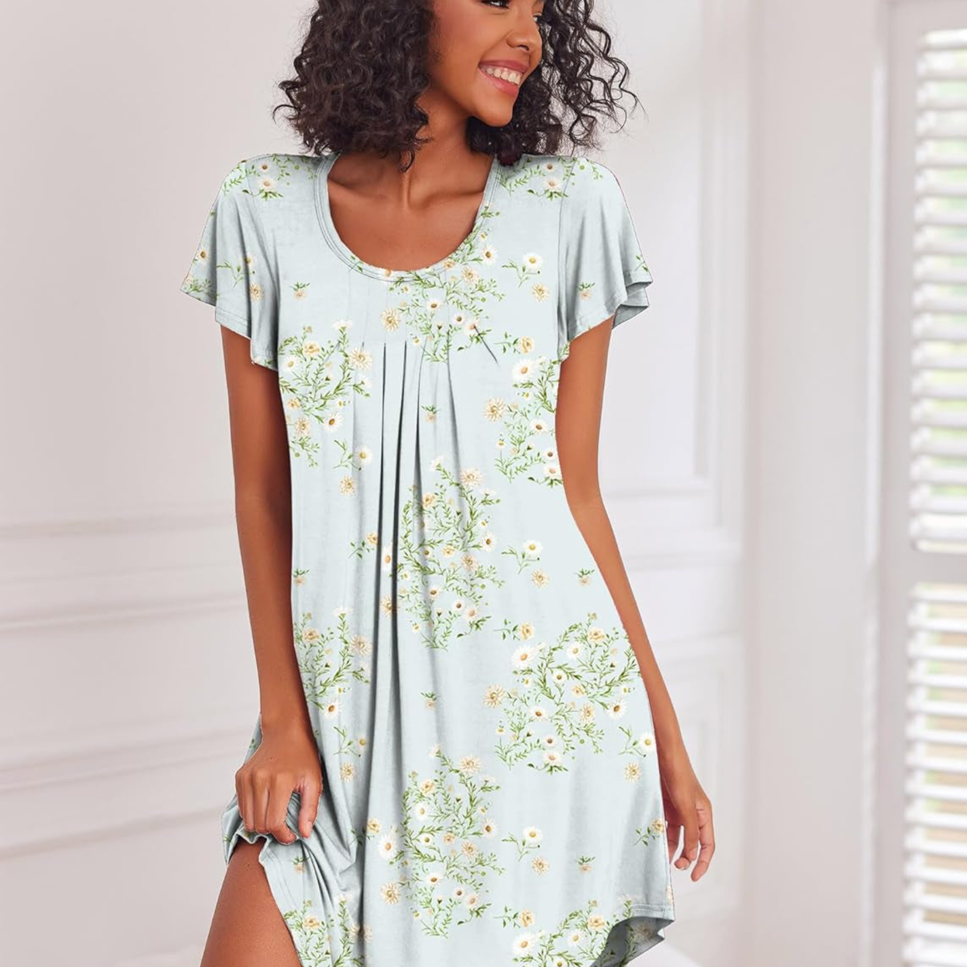 Woman wearing a light blue floral dress against a neutral background