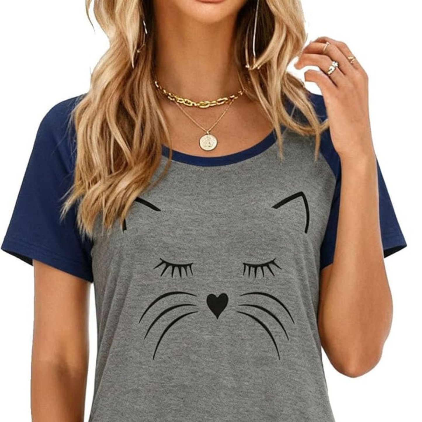 Gray t-shirt with cat face design worn by a person on a white background