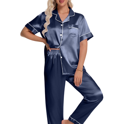 Woman wearing a navy satin pajama set on a white background